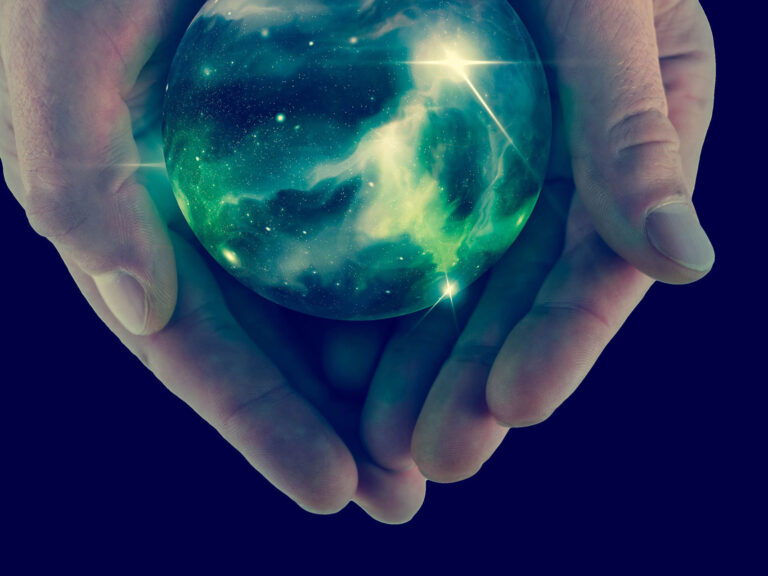 Hands holding universe psychic crystal ball